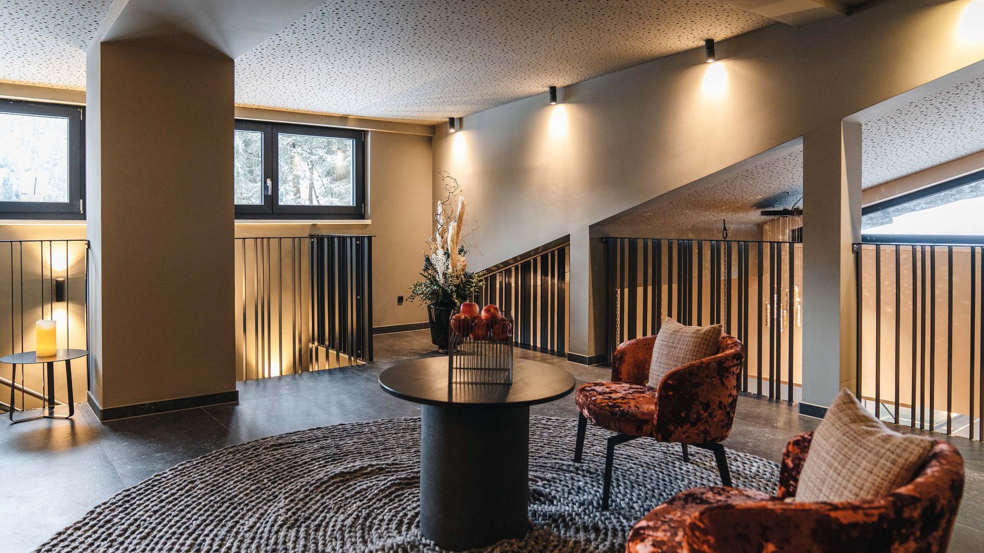 Cozy seating area with two chairs and round table on rug in modern room