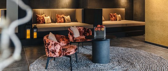 Cozy modern seating area with velvet chairs and round rug