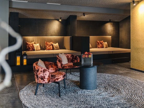 Cozy modern seating area with velvet chairs and round rug