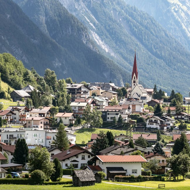 Village with church and mountains in the background on a sunny day