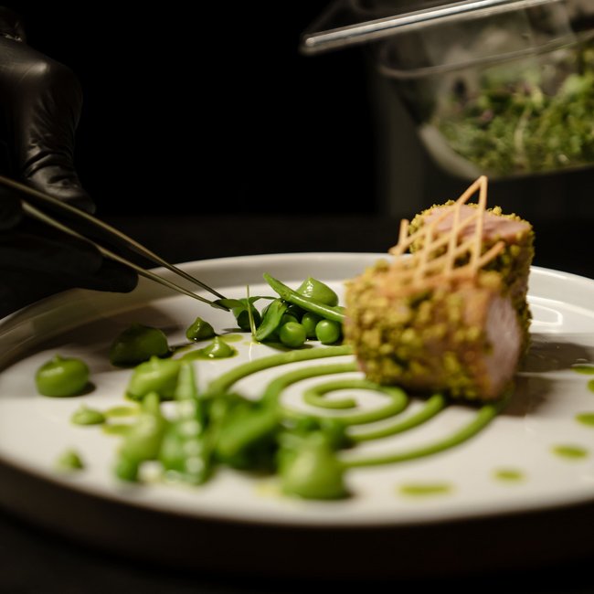 Feine Küche mit grün dekoriertem Teller und Fleisch