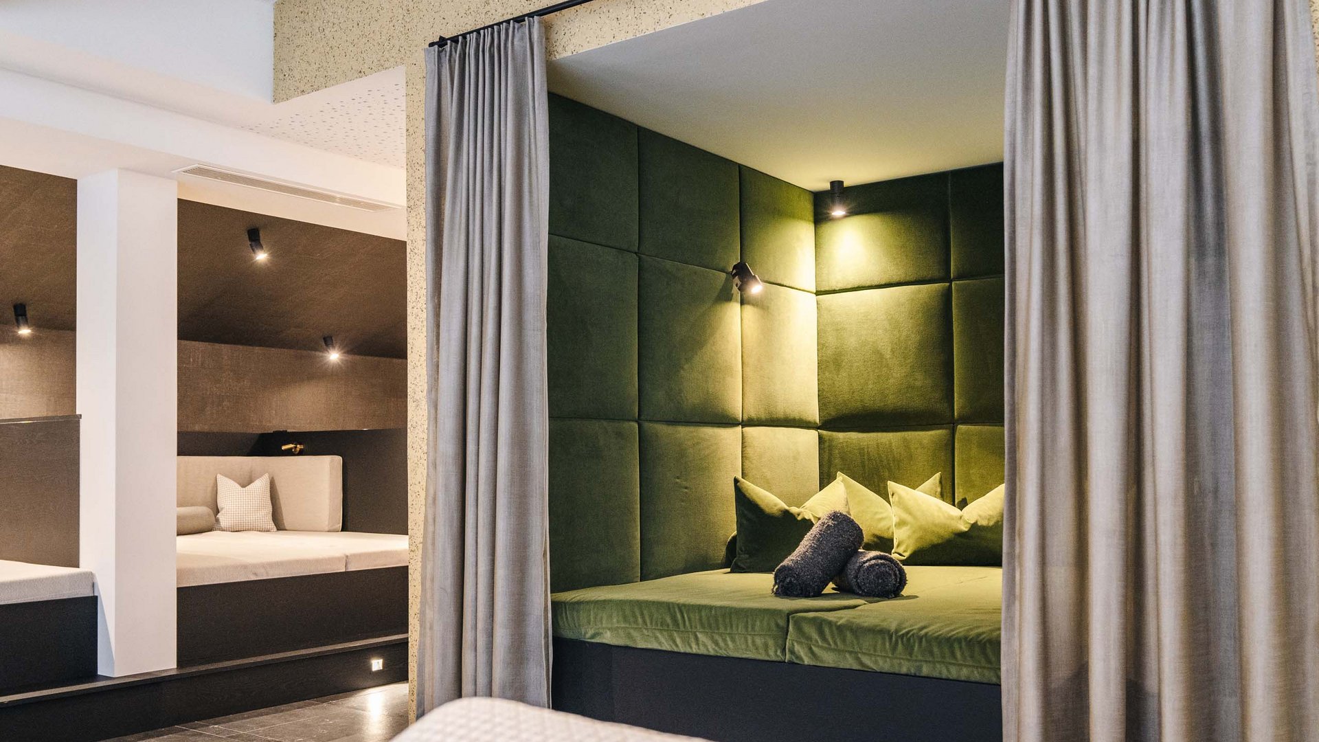 Modern relaxation room with green and white upholstery and soft lighting