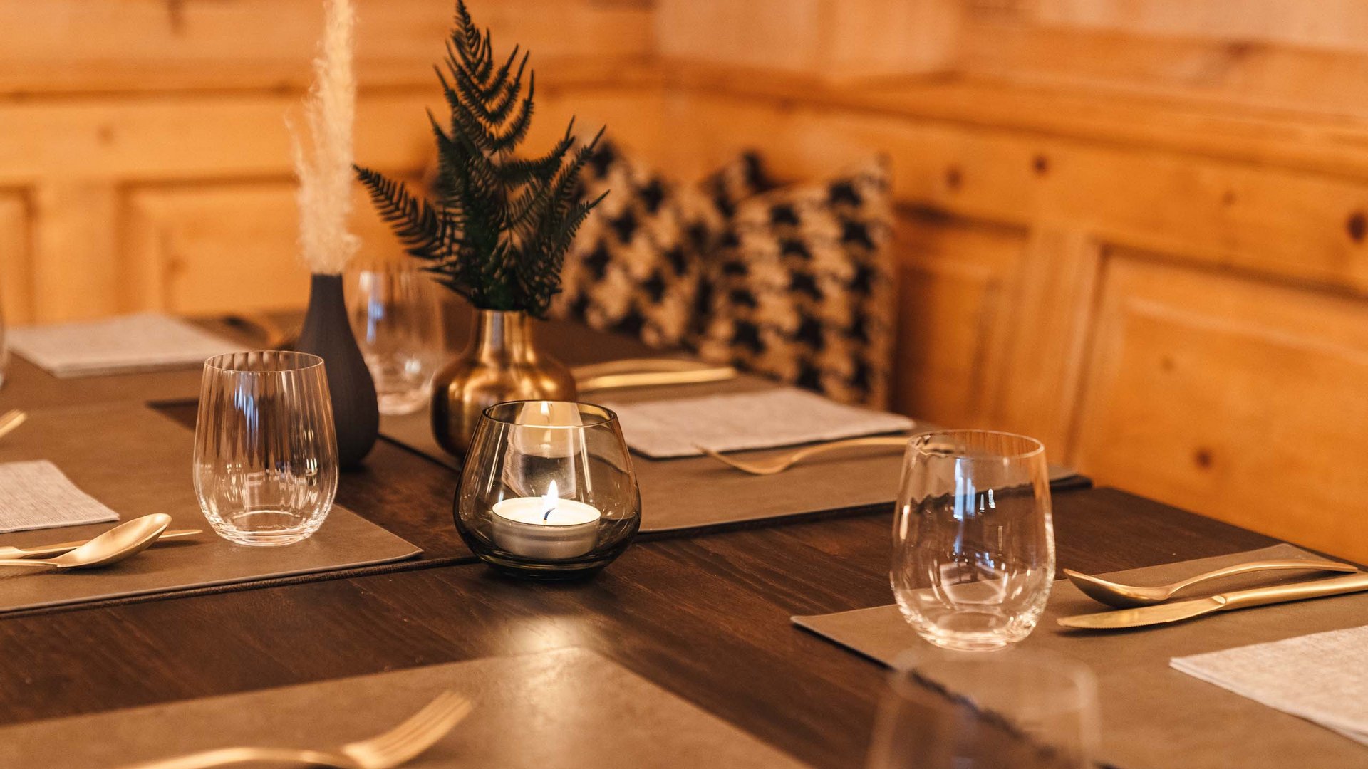Cozy set dining table with candle and decorations in wooden room
