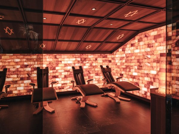 Relax room with illuminated salt stone walls and reclining chairs