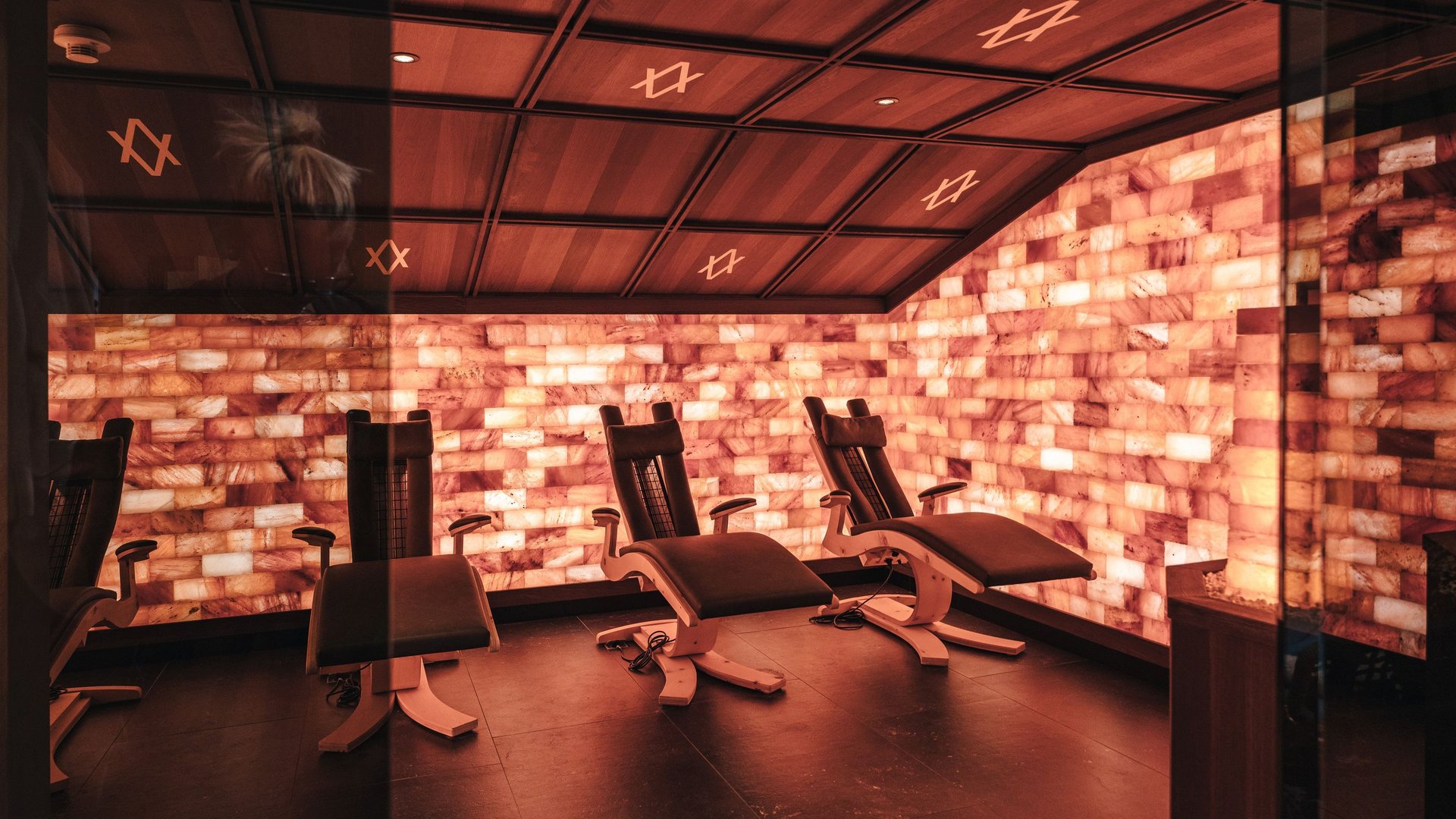 Relax room with illuminated salt stone walls and reclining chairs